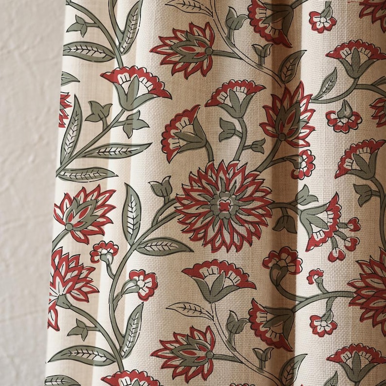 May include: Cream-colored fabric with a repeating floral pattern. The design features red flowers with gray centers and green stems and leaves. The fabric appears to be a curtain or drapery material.
