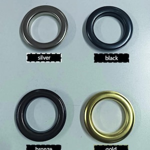 May include: Four metal grommets in silver, black, bronze, and gold. Each grommet is circular with a central opening. Text labels below each grommet read "silver", "black", "bronze", and "gold".