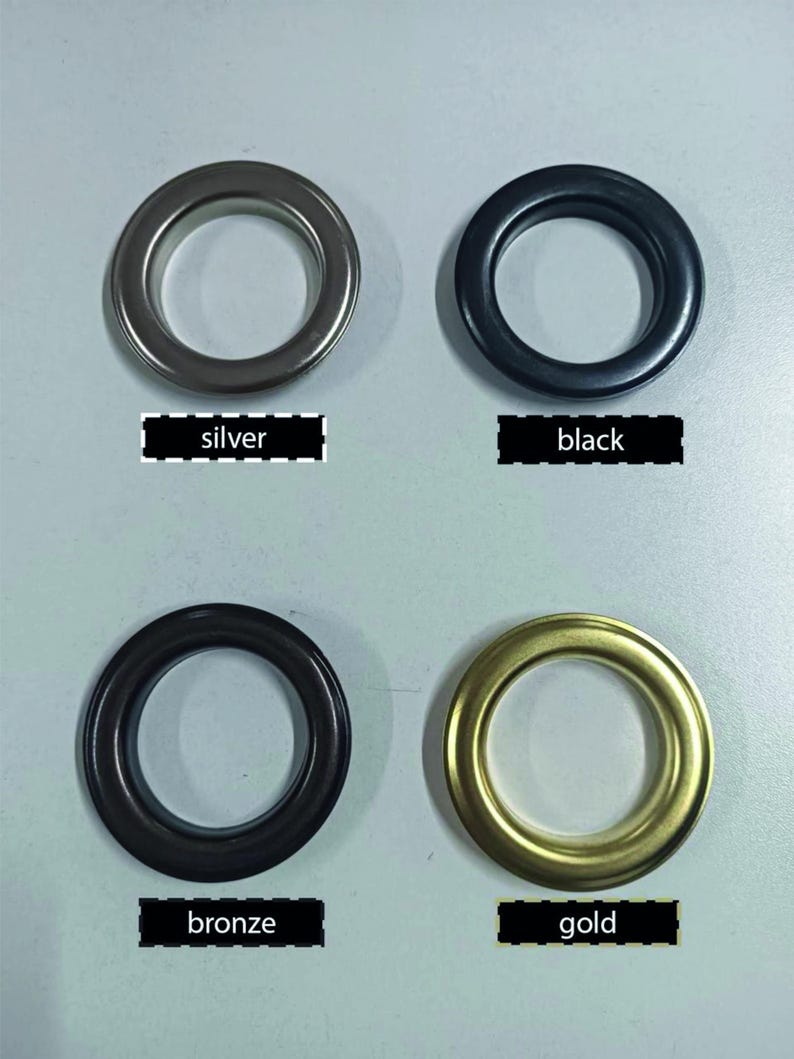 May include: Four metal grommets in silver, black, bronze, and gold. Each grommet is circular with a central opening. Text labels below each grommet read "silver", "black", "bronze", and "gold".