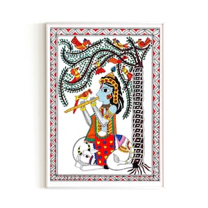 May include: A colorful folk art painting depicting a blue-skinned figure playing a flute while sitting on a white cow. The figure is surrounded by a green tree with red flowers and orange birds. The painting is framed in white.