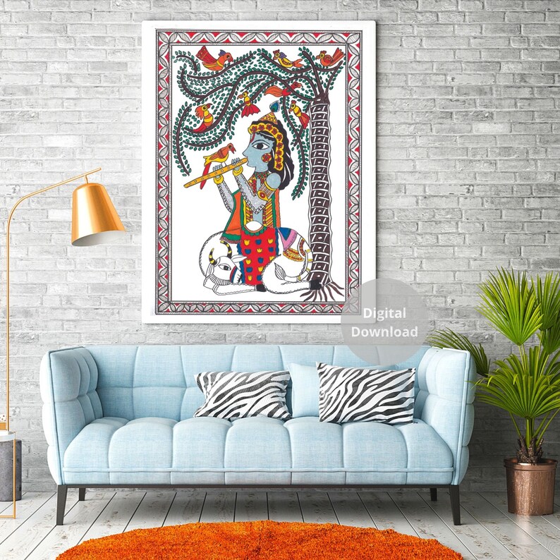 May include: A colorful painting of a Hindu deity playing a flute, sitting under a tree with birds. The painting is framed in a white border with a red and white patterned border.