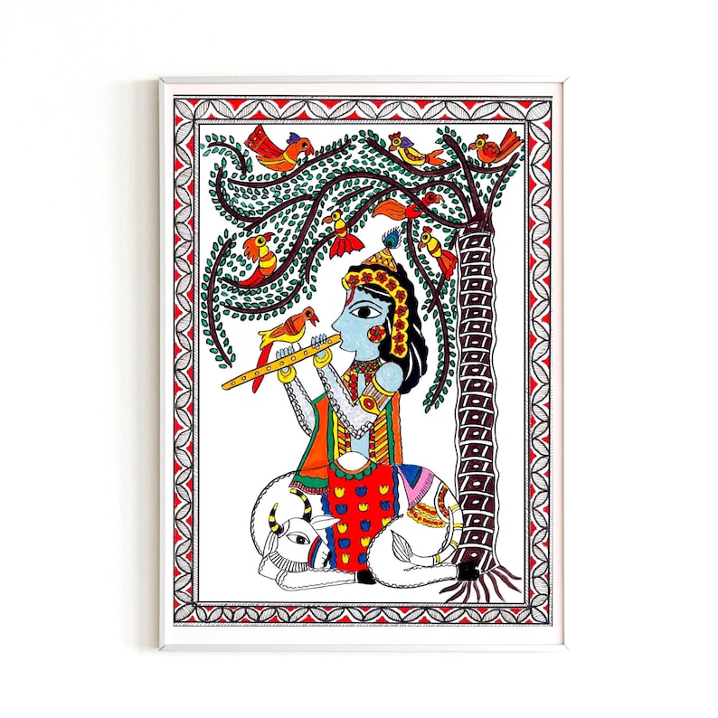 May include: A colorful folk art painting depicting a blue-skinned figure playing a flute while sitting on a white cow. The figure is surrounded by a green tree with red flowers and orange birds. The painting is framed in white.