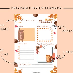 Könnte beinhalten: Druckbarer Tagesplaner mit Herbstthema. Der Planer zeigt einen Bären, ein Eichhörnchen und Herbstblätter. Er enthält Abschnitte für Ziele, Top-Prioritäten, To-Do-Liste, positive Affirmation und große Ideen.
