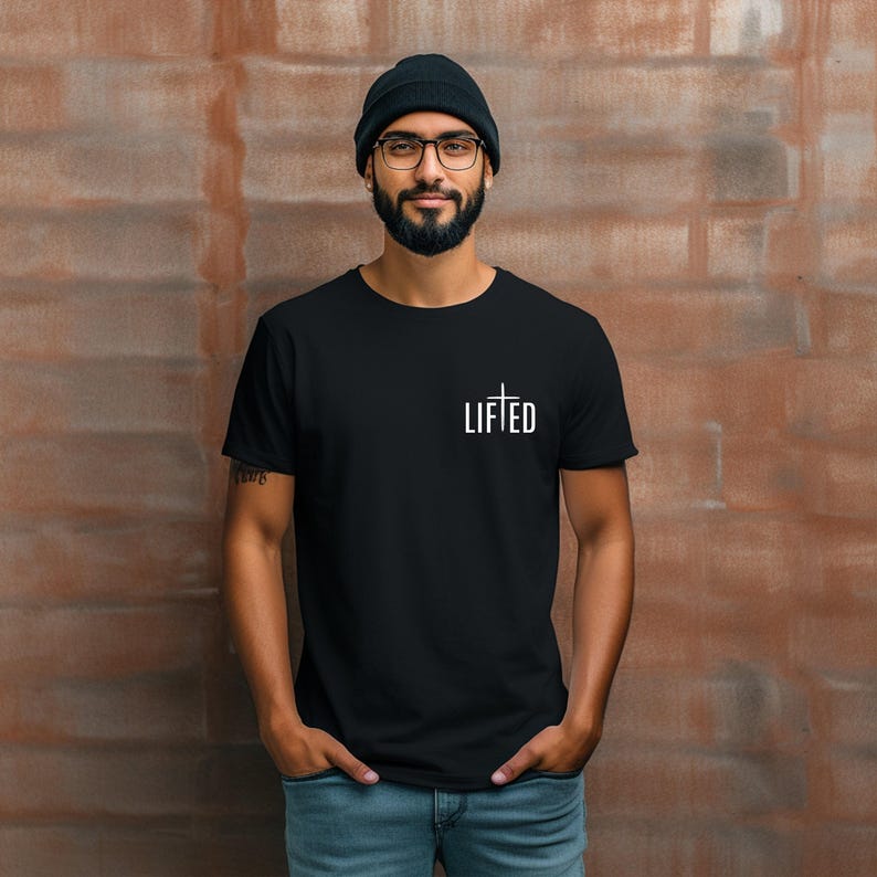 May include: A black t-shirt with a white cross and the word 'LIFTED' printed on the front.
