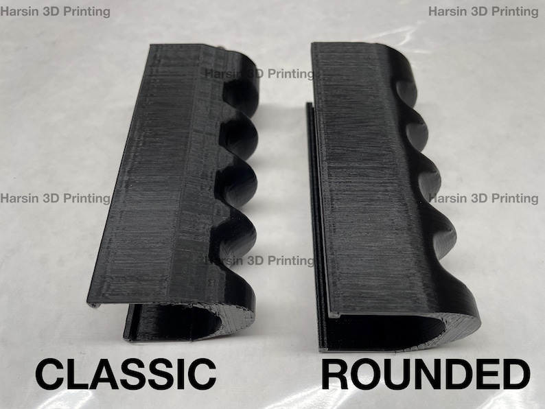 May include: Two 3D printed black plastic pieces, one with a classic design and the other with a rounded design. Both pieces have a series of ridges along the side. The text "CLASSIC" is printed below the first piece and "ROUNDED" is printed below the second piece.