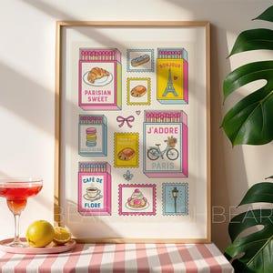 May include: A framed print with illustrations of Parisian matchboxes and stamps. The matchboxes display text such as "PARISIAN SWEET" and "J'ADORE PARIS", with images of pastries, the Eiffel Tower, and a bicycle. The artwork is set against a white background.
