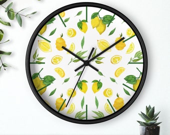 May include: A black and white clock with a white background and a lemon pattern. The clock has black hands and a black frame.