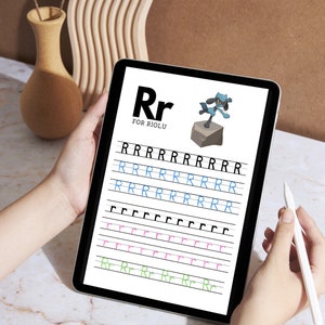 May include: A digital tablet displaying a printable worksheet for learning the letter "R". The worksheet features a cartoon Riolu Pokemon and includes lines for tracing the letter in different sizes and styles. The text "Rr for Riolu" is at the top of the page.