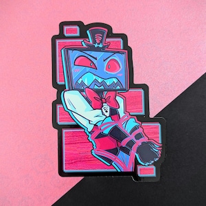 May include: A sticker featuring a cartoon character with a television screen for a head, wearing a bow tie and bound with red and blue straps. The character has red eyes and a top hat. The background is pink and black.