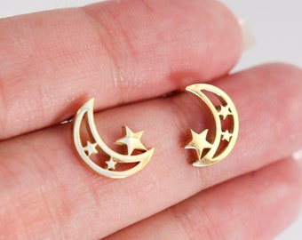 Brincos de titânio com lua e estrelas, joias minimalistas com inspiração celestial.