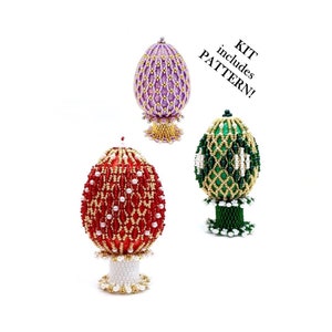 May include: Three beaded Easter egg ornaments, one purple, one red, and one green, each with a beaded stand. The text "KIT includes PATTERN!" is in the upper right corner of the image.