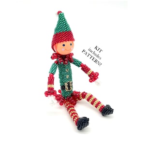 May include: A beaded elf ornament kit, featuring a green and red elf sitting with a white beard. The kit includes a pattern.