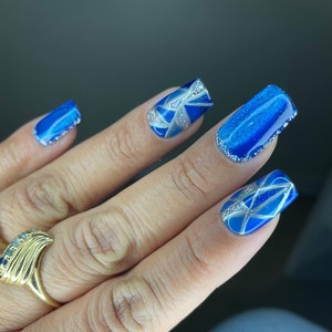 Blue cat eye press on nails with mosaic design. Short square in pic.