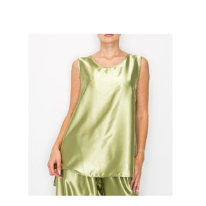May include: A sleeveless satin top in a light green color. The top has a round neckline and a relaxed fit.