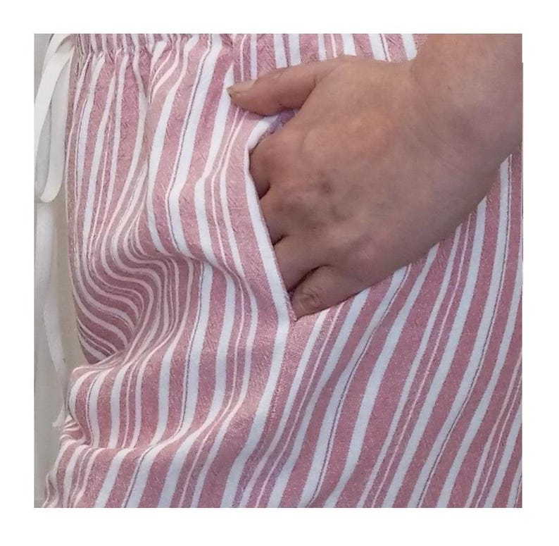 May include: Pink and white striped pajama pants with a side pocket.