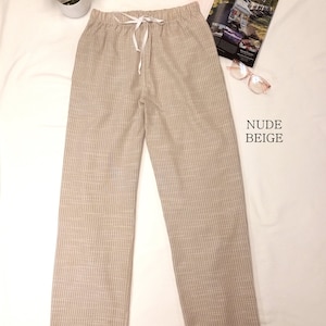 May include: Beige striped pants with a white drawstring waist.