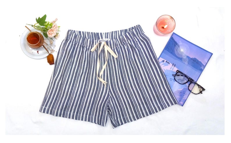May include: Blue and white striped linen shorts with a drawstring waist.