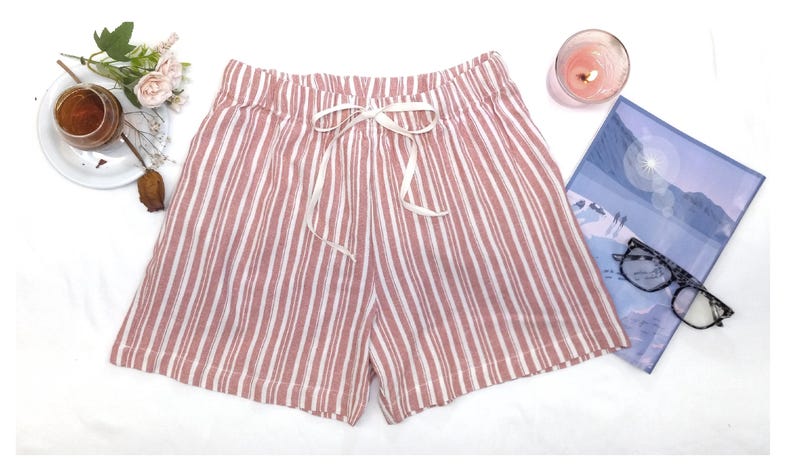 May include: Pink and white striped pajama shorts with a white drawstring tie.