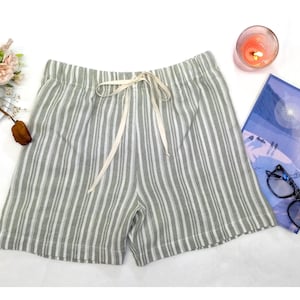 May include: Gray and white striped linen shorts with a white drawstring tie.