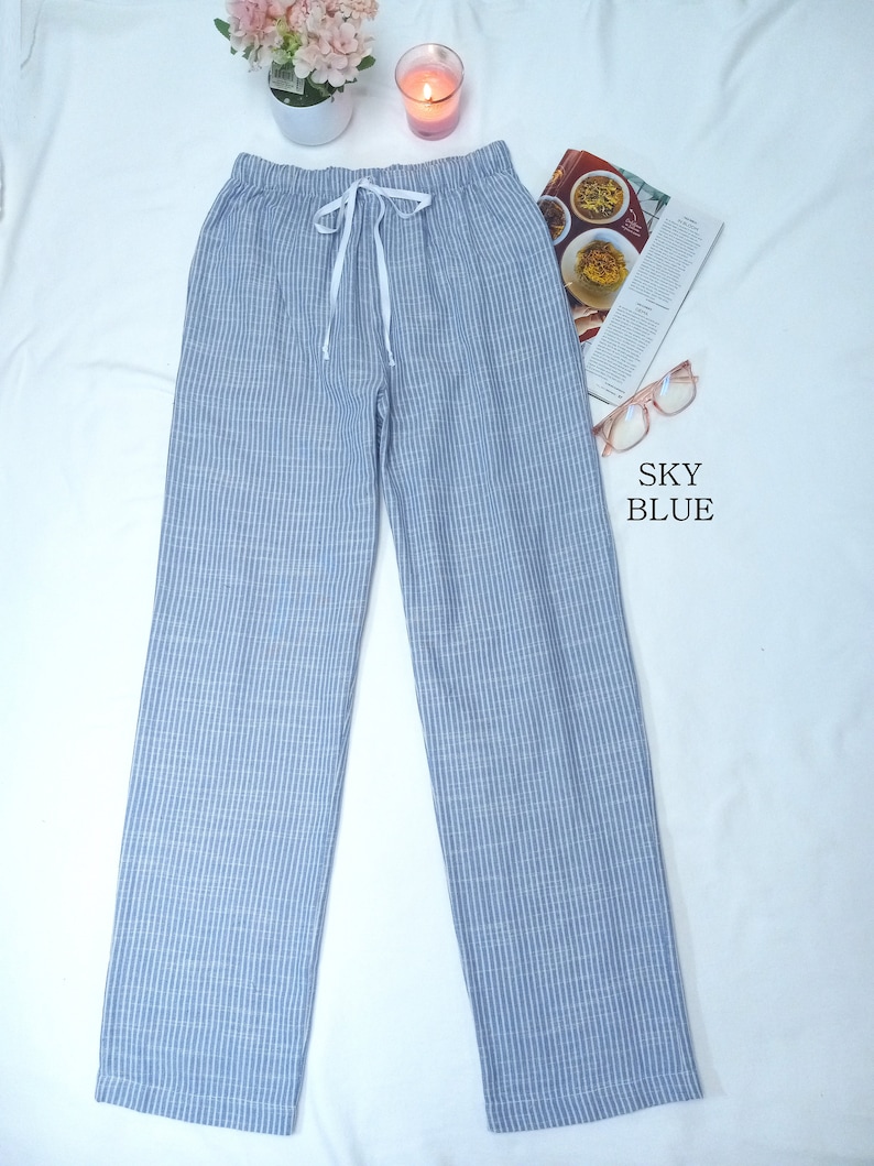 May include: A pair of light blue striped pants with a white drawstring. The pants are made of a soft, comfortable fabric and have a relaxed fit.