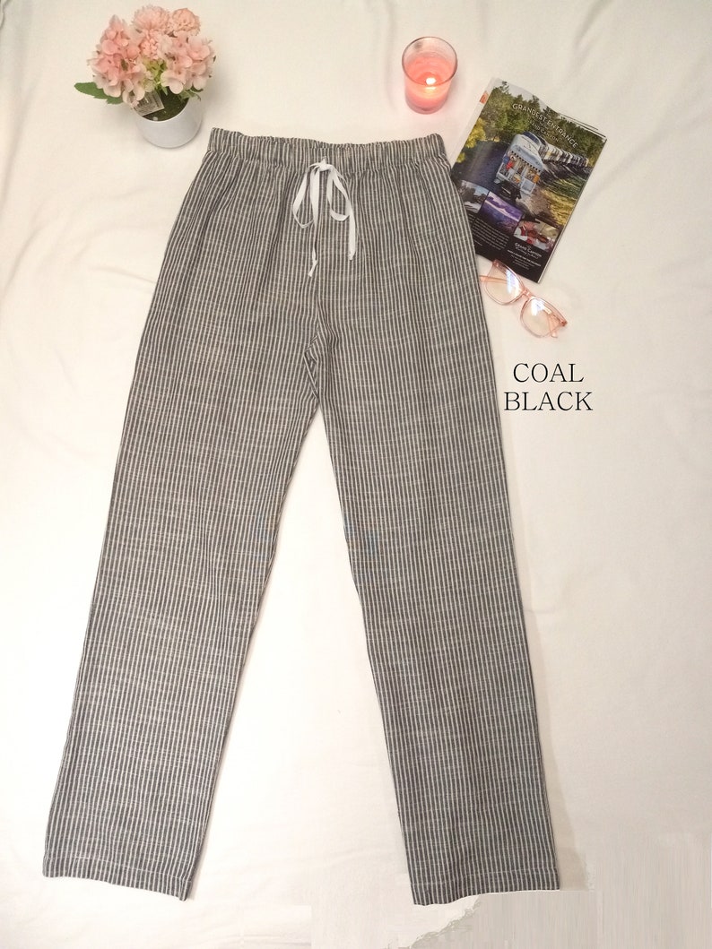 May include: Gray and white striped pants with a drawstring waist. The pants are made of a soft, comfortable fabric and have a relaxed fit.