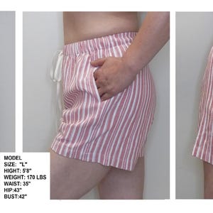 May include: Red and white striped pajama shorts with a drawstring waist. The model is 5'8" tall, weighs 170 lbs, has a 35 inch waist, 43 inch hips, and a 42 inch bust.