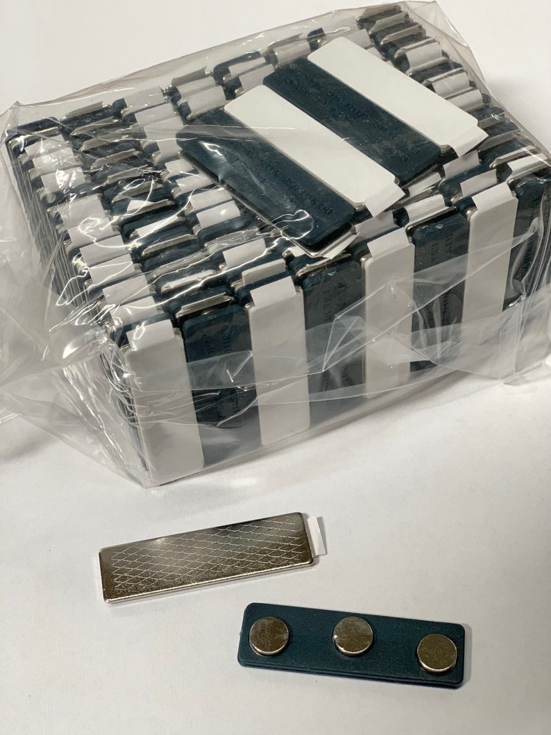 May include: A pack of 25 black and white striped magnetic name tags with a silver magnetic name tag and a grey magnetic name tag with three magnets.