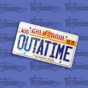May include: California license plate with the text "OUTATIME" in blue, with "AUG" and "CALIFORNIA" at the top. The license plate has a white background and a blue background with DeLorean car silhouettes.
