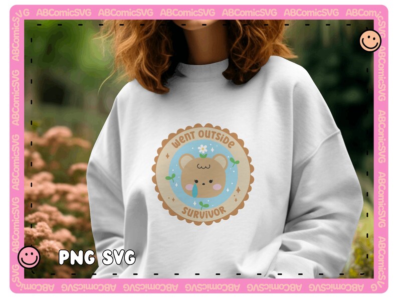 May include: A white sweatshirt with a brown bear illustration wearing a flower crown. The bear is surrounded by a blue circle with the text "Went Outside Survivor" in brown lettering.