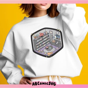 May include: White sweatshirt with a graphic print of a cozy living room with a bookshelf, a couch, and a coffee table. The graphic is in a cartoon style with pastel colors.