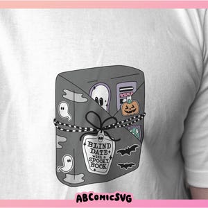 May include: A gray and white book with the text "Blind Date with a Spooky Book" on the front cover. The book is wrapped in black and white string and decorated with ghosts, a pumpkin, and other Halloween-themed elements.