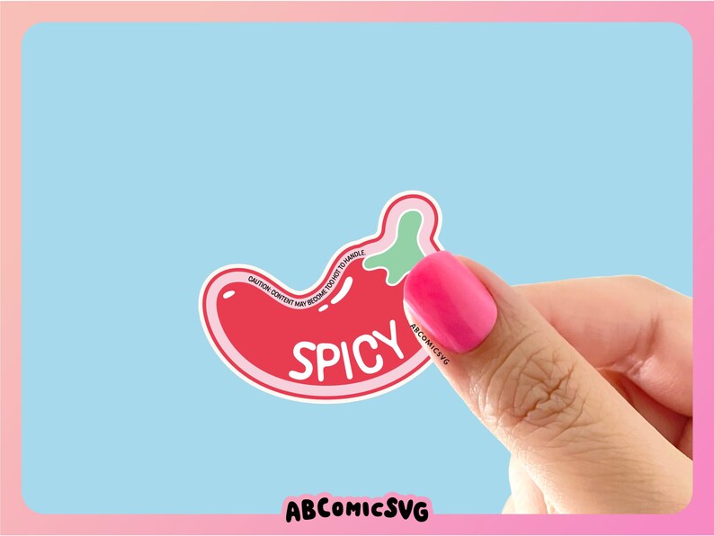 May include: A red and green chili pepper sticker with the word "Spicy" written on it. The sticker is being held by a hand with pink nail polish.