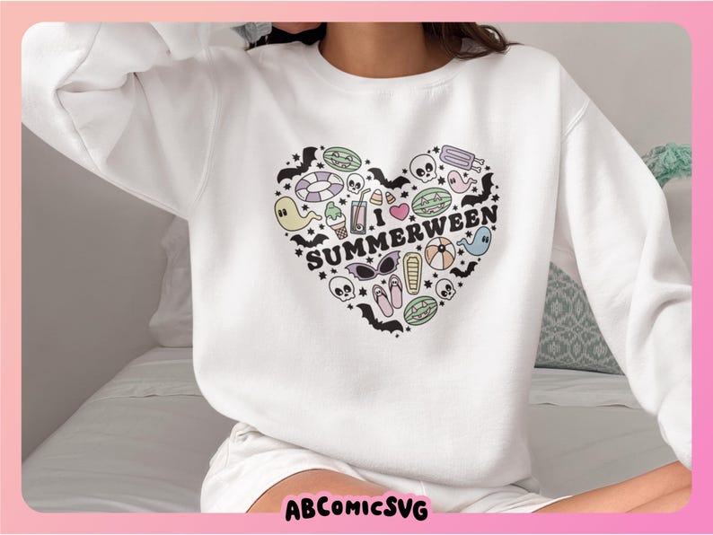 May include: White sweatshirt featuring a heart-shaped design with the text "I Summerween". The graphic is filled with summer and Halloween-themed illustrations. The sweatshirt has long sleeves and is made of a soft material.