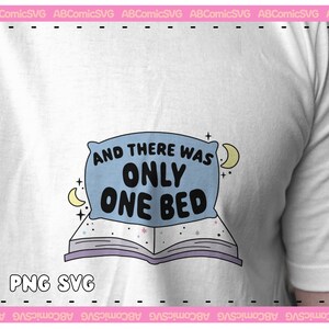 May include: A white t-shirt with a blue pillow and a book with stars. The pillow has the text "And there was only one bed".
