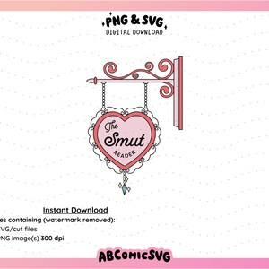 May include: A pink heart-shaped sign with the text "The Smut Reader" hanging from a decorative metal bracket. The sign is on a white background.