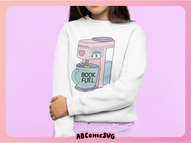 May include: White sweatshirt featuring a pastel pink coffee maker graphic with a heart and the text "BOOK FUEL" on a teal mug. The coffee maker is pouring coffee into the mug. The sweatshirt is a comfortable, casual style.