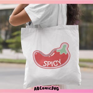 May include: White tote bag with a red and green chili pepper graphic and the word "Spicy" printed on it.