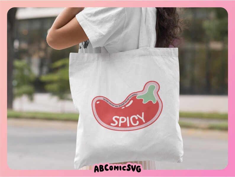 May include: White tote bag with a red and green chili pepper graphic and the word "Spicy" printed on it.