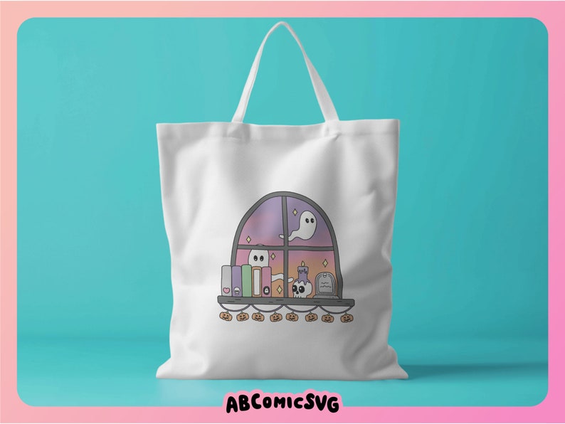 May include: White tote bag with a Halloween illustration. The design depicts a window with ghosts, books, a skull, and pumpkins. The text "ABCOMICSVG" is at the bottom of the bag.