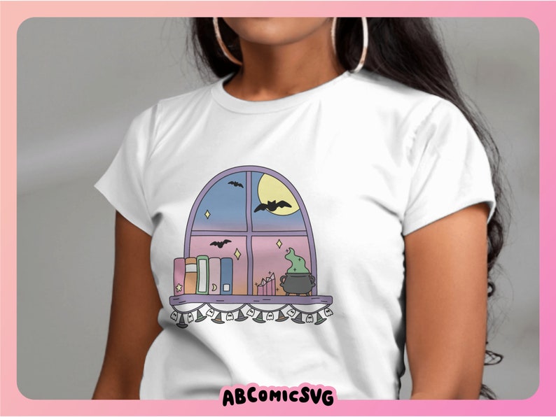May include: White t-shirt with a cartoon window design. The window shows a moon, bats, and a cauldron. Books and candles sit on the sill. The text "ABCOMICSVG" is at the bottom of the image.