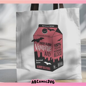 May include: A white tote bag with a pink and black illustration of a carton of "Fresh Blood Vampire Aid" juice. The carton has bats and the text "No Humans Harmed", "Unnaturally Sourced", "100% Vegan Human Blood", "Survival Juice", and "Bloody Delicious".