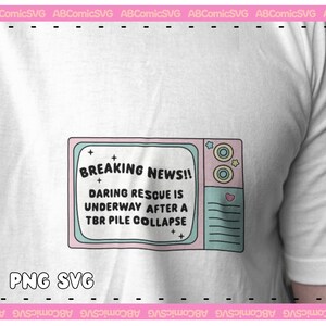 May include: A white t-shirt with a pink and blue cartoon television screen graphic. The screen says "BREAKING NEWS!! DARING RESCUE IS UNDERWAY AFTER A TBR PILE COLLAPSE". The text "PNG SVG" is below the graphic.