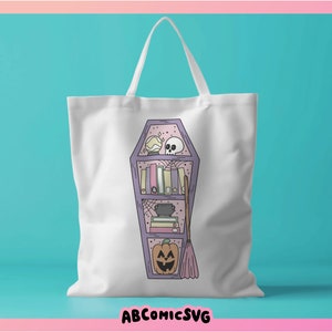 May include: A white tote bag featuring a purple coffin-shaped bookshelf design. The bookshelf is filled with books, a skull, a cauldron, a pumpkin, and a broom.