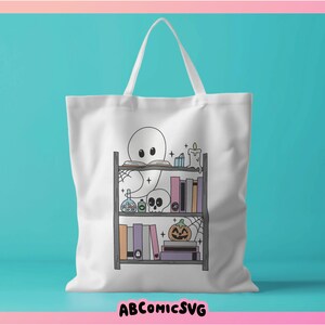 May include: White tote bag featuring a ghost reading a book on a bookshelf filled with books, potions, and a pumpkin. The bookshelf has a spiderweb design.