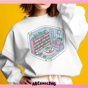 May include: White sweatshirt with a colorful illustration of a room with a bookshelf, a couch, a coffee table, and a ladder. The illustration is surrounded by a light blue border.