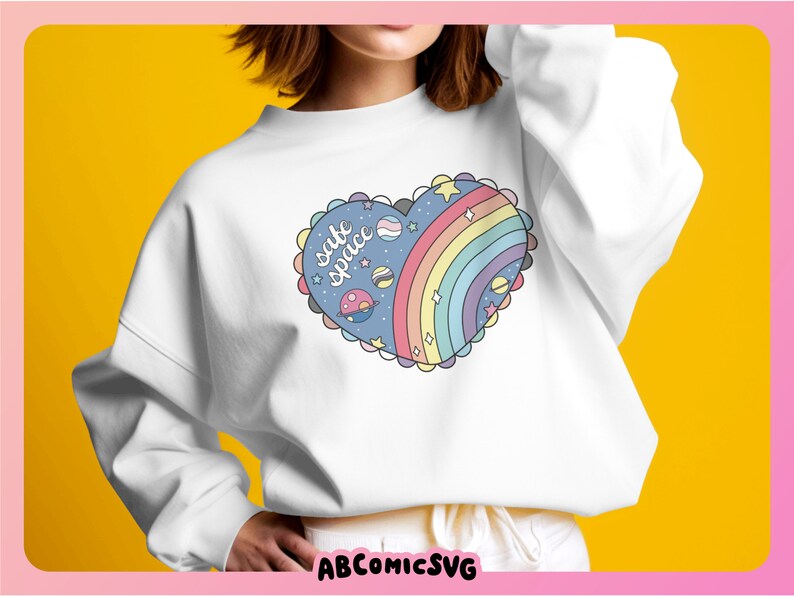 May include: White sweatshirt with a rainbow and planets design in a heart shape. The design says "safe space" in a handwritten font.
