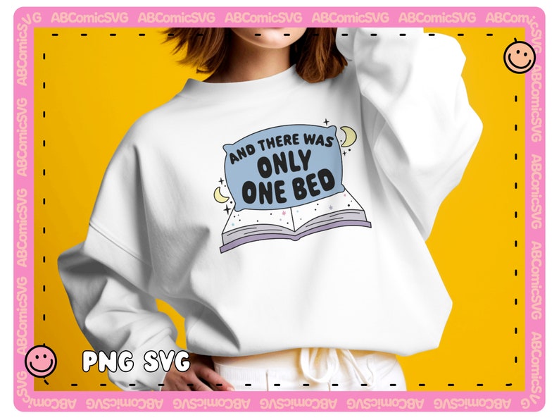 May include: White sweatshirt with a blue pillow and open book graphic. The text on the graphic reads "And there was only one bed."