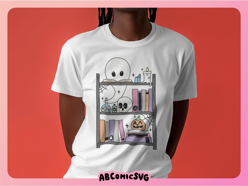May include: White t-shirt featuring a graphic of a ghost reading a book on a bookshelf decorated with Halloween items. The bookshelf includes a skull, a pumpkin, potions, and candles.