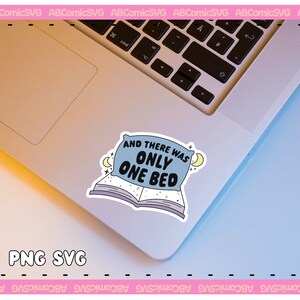 May include: A blue and white sticker with a pillow and a book. The sticker says "And there was only one bed". The sticker is on a silver laptop.