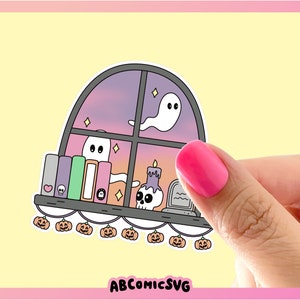 May include: A Halloween sticker depicting a window scene with ghosts, books, a candle, and a tombstone. The window has a purple and orange sunset background. A string of jack-o'-lanterns decorates the bottom. The sticker has the text "ABCOMICSVG".